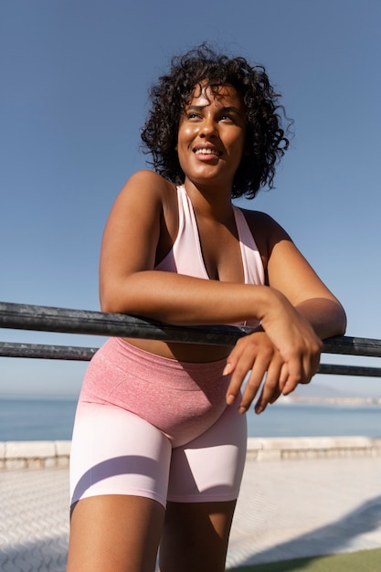 Medium shot smiley woman at beach