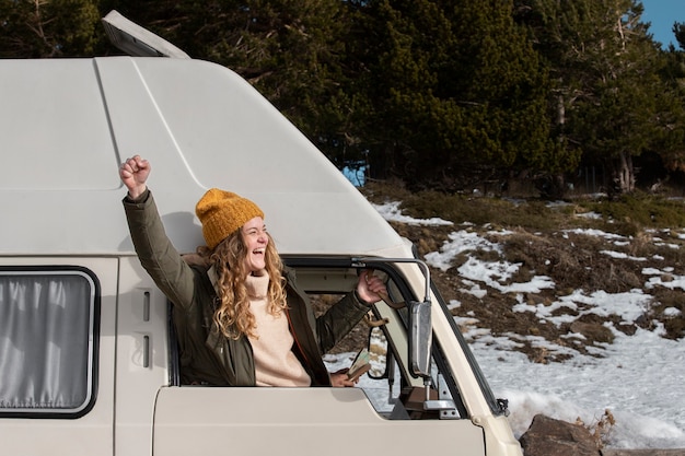 Medium shot smiley woman in campervan