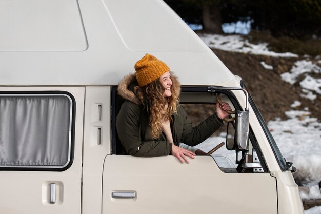 Medium shot smiley woman in campervan