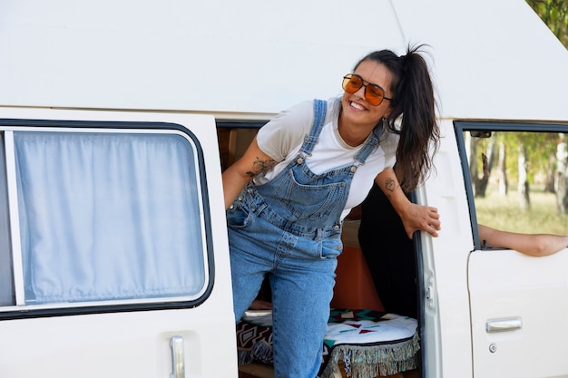 Medium shot smiley woman in campervan