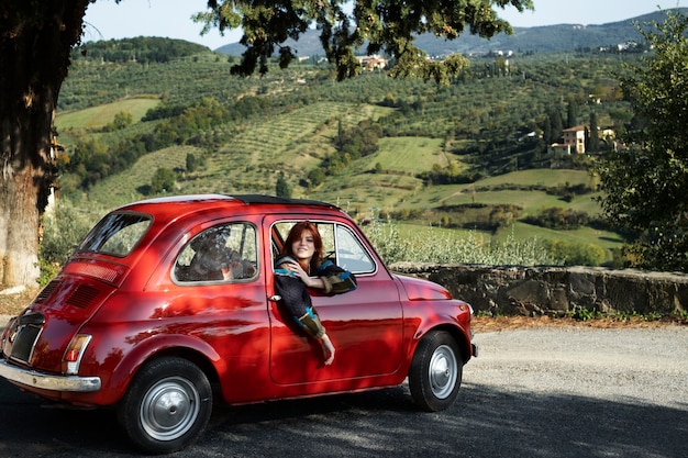 Medium shot smiley woman in car