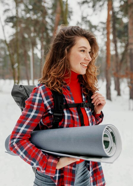 Medium shot smiley woman carrying mat