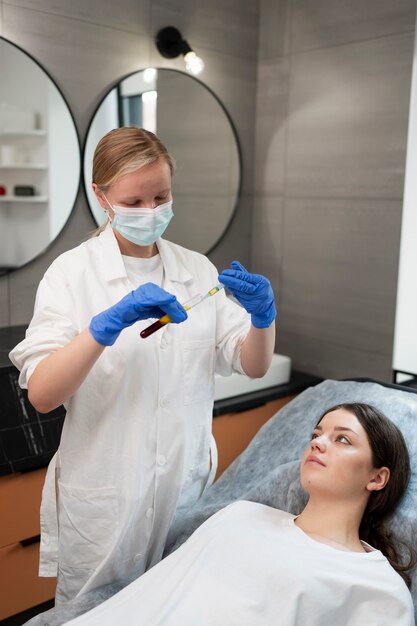 Medium shot smiley woman at clinic