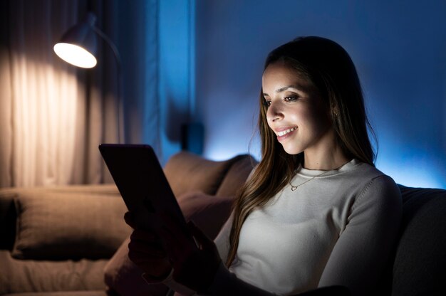 Medium shot smiley woman on couch