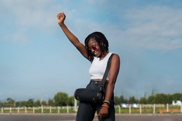 Medium shot smiley woman dancing outdoors