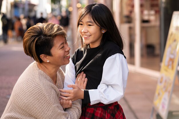 Medium shot smiley woman and girl