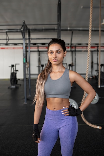 Medium shot smiley woman at gym