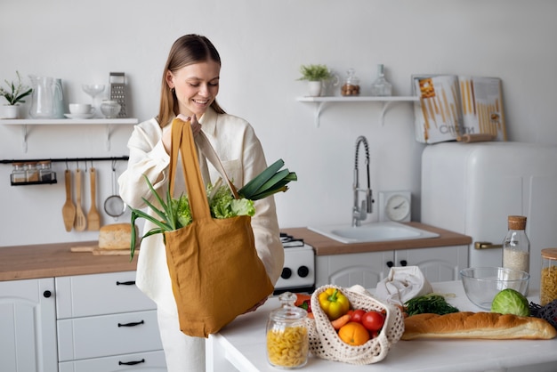 Medium shot smiley woman holding bag