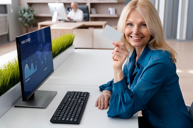 Free photo medium shot smiley woman holding business card