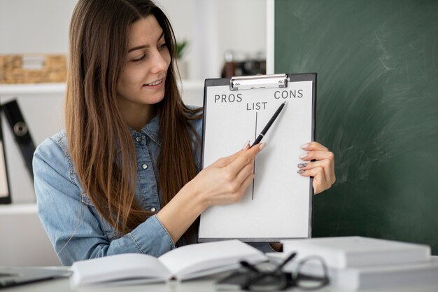 Medium shot smiley woman holding clipboard