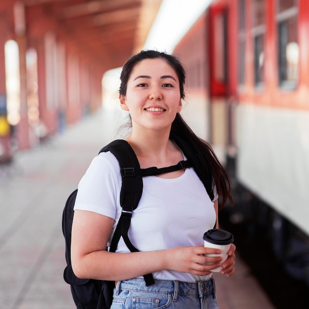 Medium shot smiley woman holding coffee cup