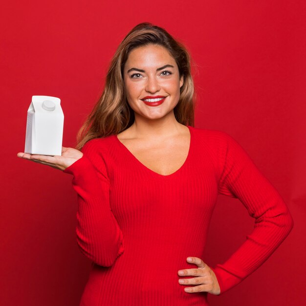 Medium shot smiley woman holding container