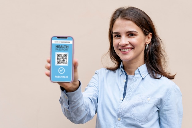 Medium shot smiley woman holding device