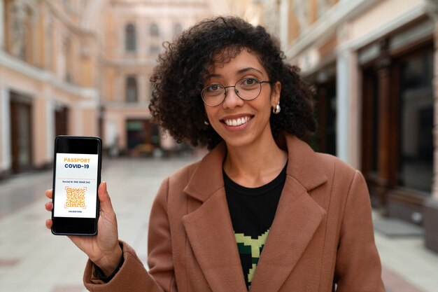 Medium shot smiley woman holding device