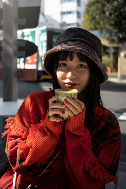 Medium shot smiley woman holding drink