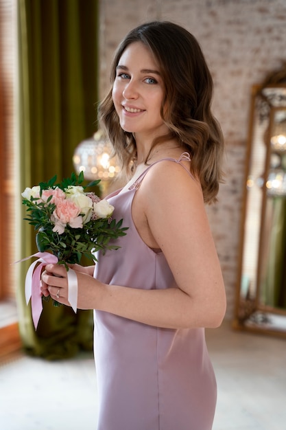 Medium shot smiley woman holding flowers