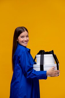 Medium shot smiley woman holding gift boxes