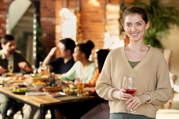 Medium shot smiley woman holding glass