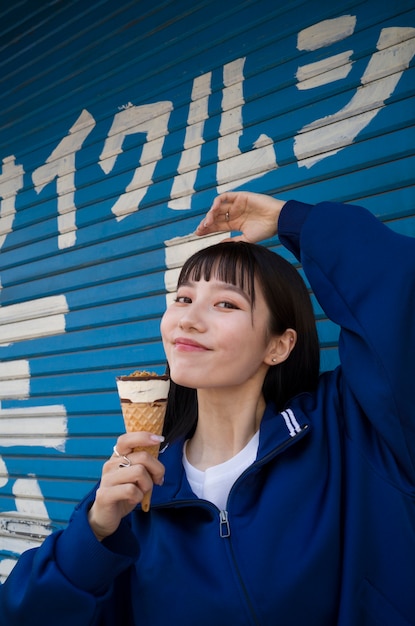 Medium shot smiley woman holding ice cream cone