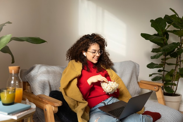 Medium shot smiley woman holding laptop