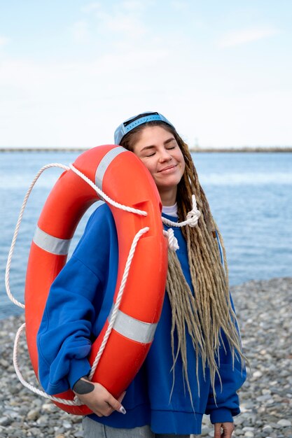 Medium shot smiley woman holding lifeline