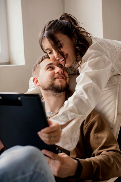 Medium shot smiley woman holding man