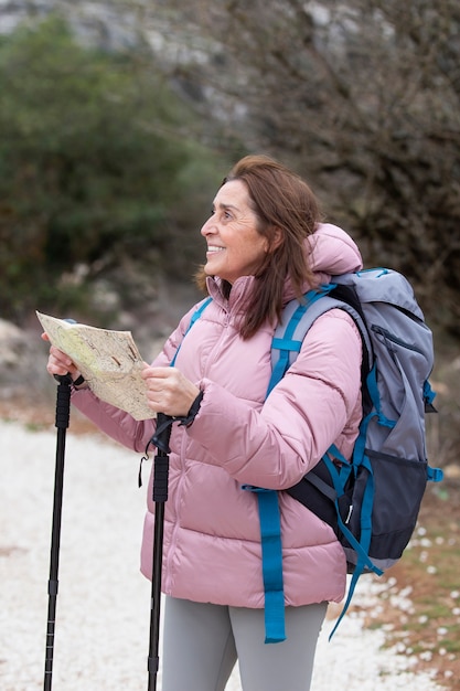 Free photo medium shot smiley woman holding map