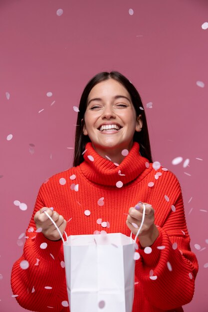 Medium shot smiley woman holding paper bag