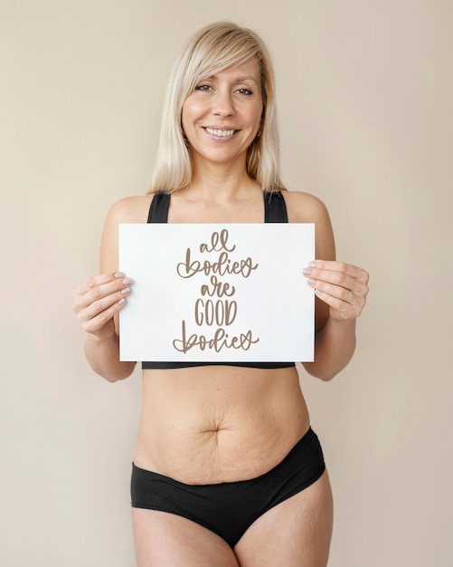 Medium shot smiley woman holding paper