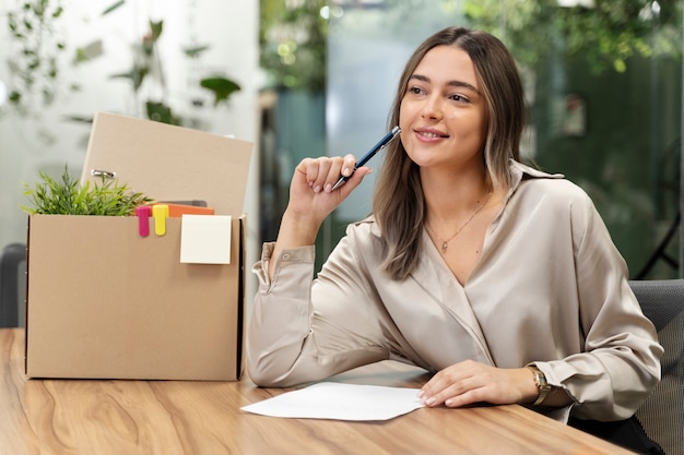 Medium shot smiley woman holding pencil