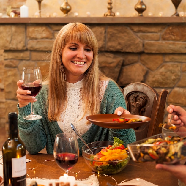 Medium shot smiley woman holding plate