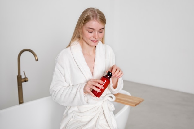 Free photo medium shot smiley woman holding product