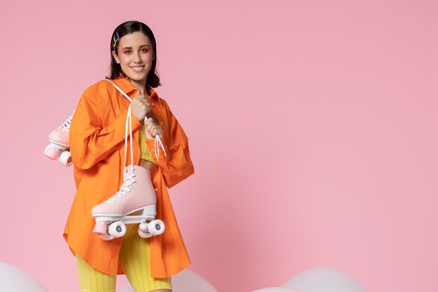 Medium shot smiley woman holding rollerskates