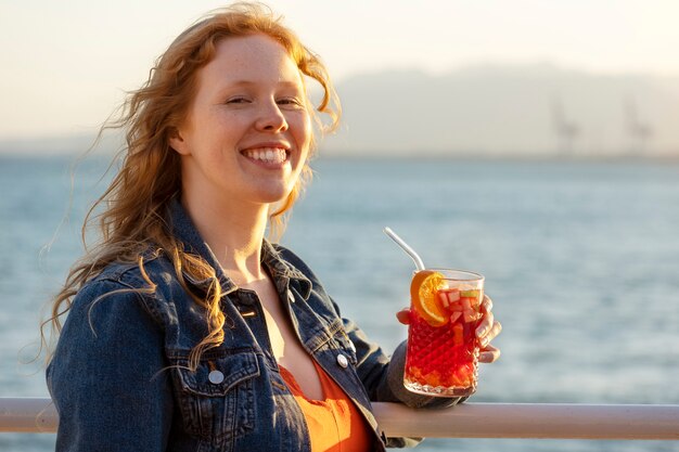 Medium shot smiley woman holding sangria