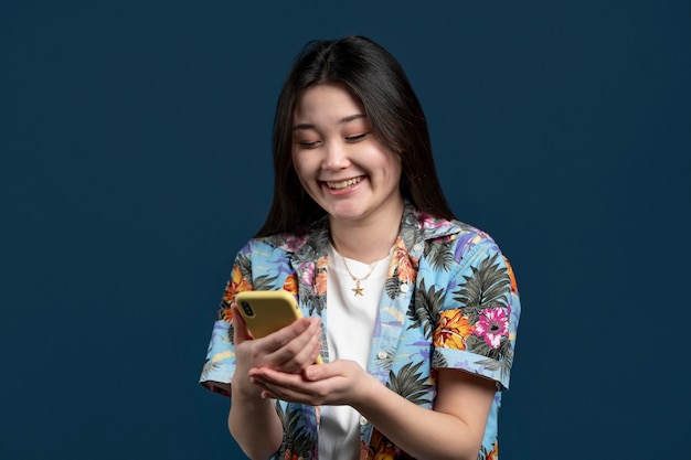 Medium shot smiley woman holding smartphone