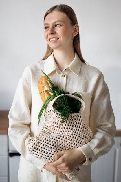 Medium shot smiley woman holding tote bag