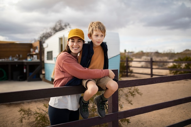 Medium shot smiley woman and kid