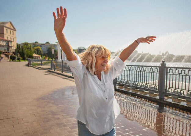 Medium shot smiley woman outdoors