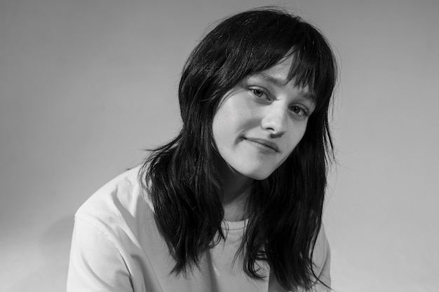 Medium shot smiley woman posing black and white