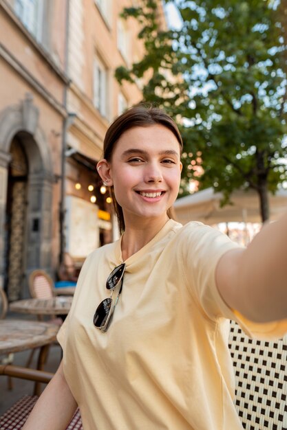 Medium shot smiley woman posing outdoors