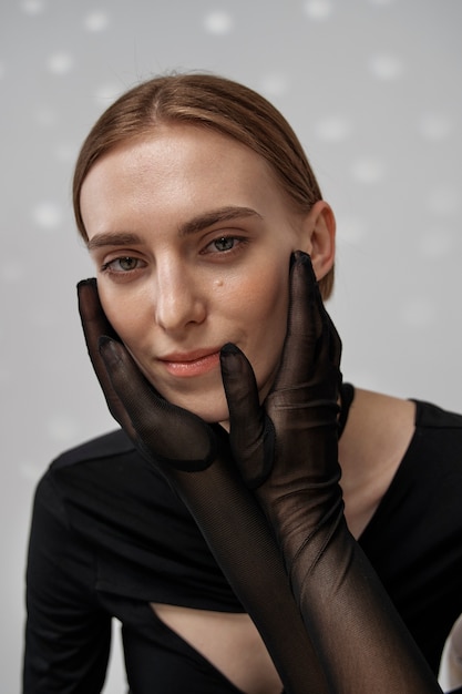 Medium shot smiley woman posing with gloves