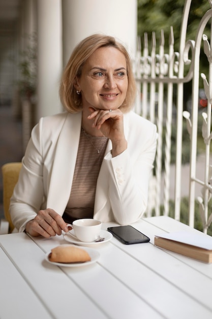 Medium shot smiley woman at restaurant