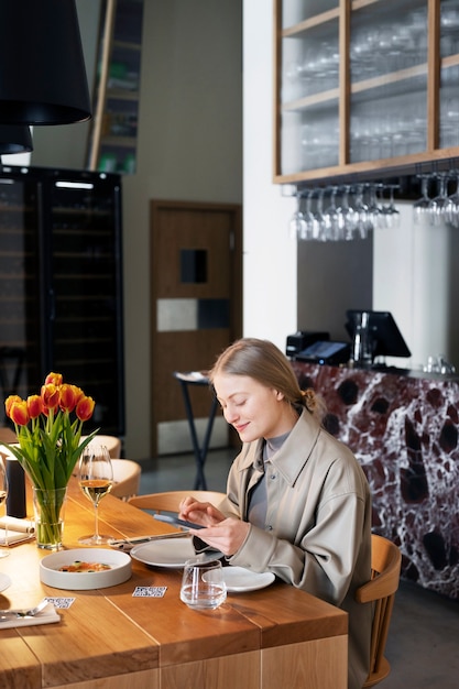 Medium shot smiley woman scanning code