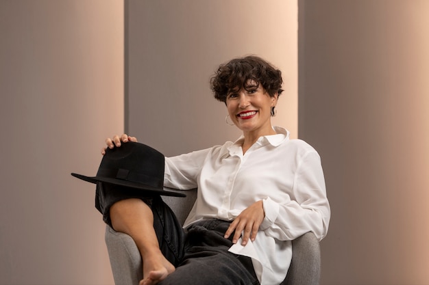 Medium shot smiley woman sitting on chair