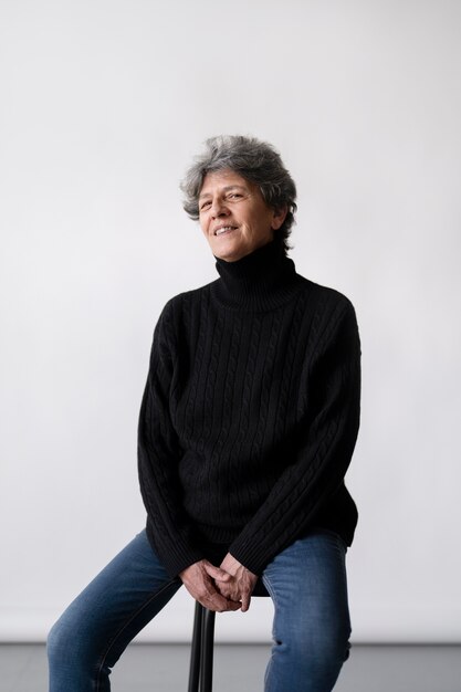 Medium shot smiley woman sitting on chair