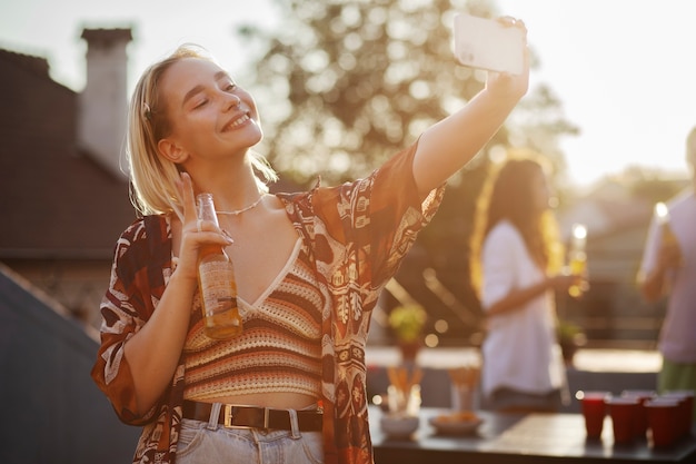 Medium shot smiley woman taking selfie