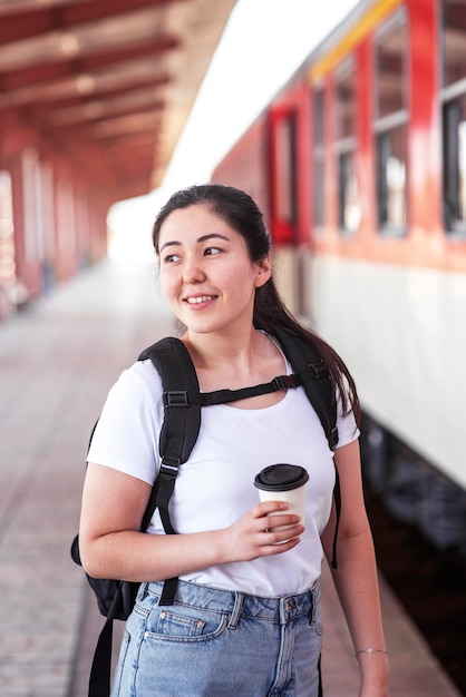 Medium shot smiley woman at train station