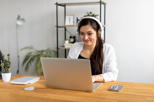 Medium shot smiley woman typing