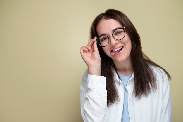 Medium shot smiley woman wearing glasses in studio