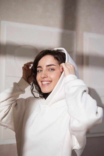 Medium shot smiley woman wearing hoodie